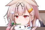  1girl baileys_(tranquillity650) ball blonde_hair chair commentary_request eyebrows_visible_through_hair gradient_hair hair_flaps hair_ornament hair_ribbon hairclip head_rest kantai_collection long_hair looking_at_viewer miss_cloud multicolored_hair pipe_in_mouth red_eyes red_hair remodel_(kantai_collection) ribbon simple_background sitting solo table white_background yuudachi_(kantai_collection) 
