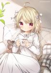  1girl absurdres ahoge bangs blonde_hair blush bow braid chestnut_mouth commentary_request couch cup dress eyebrows_visible_through_hair feet_out_of_frame hair_between_eyes hair_bow highres holding holding_cup kohaku_muro long_hair long_sleeves looking_at_viewer mug nightgown on_couch original parted_lips pillow red_eyes sitting solo steam stuffed_animal stuffed_toy teddy_bear twitter_username very_long_hair white_bow white_dress 