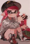  0_05kmgrn 1girl bangs baseball_cap black_headwear black_shorts blunt_bangs candy closed_mouth commentary cross-laced_footwear domino_mask eyebrows_visible_through_hair food grey_background grey_eyes gym_shorts hat high_tops highres holding holding_food ink_tank_(splatoon) inkling inkling_(language) lollipop long_hair looking_at_viewer mask pink_hair pointy_ears print_hat shoes shorts simple_background sitting solo splatoon_(series) splatoon_2 symbol_commentary tentacle_hair white_footwear 