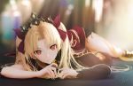  1girl blonde_hair blurry crown depth_of_field ereshkigal_(fate/grand_order) fate/grand_order fate_(series) long_hair looking_at_viewer lying ojay_tkym on_stomach red_eyes red_ribbon ribbon signature single_thighhigh skull_collar solo solo_focus thighhighs twintails 