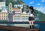  1girl architecture black_hair black_legwear black_skirt building city cloud cloudy_sky commentary_request day from_behind fubuki_(kantai_collection) hand_on_own_face highres house kantai_collection kneehighs medium_hair mountain pier ponytail scenery school_uniform serafuku shirt shoes sidelocks skirt sky solo standing wasabi60 water white_shirt 
