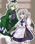  2girls arm_up black_headwear black_skirt closed_mouth commentary_request detached_sleeves dress flat_chest frilled_sleeves frills ghost_tail green_dress green_eyes green_hair grey_eyes grey_hair hat highres holding holding_clothes holding_hat japanese_clothes kaigen_1025 kariginu long_hair long_sleeves mononobe_no_futo multiple_girls ofuda ofuda_on_clothes one_side_up open_mouth ribbon-trimmed_sleeves ribbon_trim short_hair skirt soga_no_tojiko tate_eboshi touhou v-shaped_eyebrows wavy_hair white_sleeves wide_sleeves 