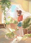  1girl bed blue_sky bokchois brown_eyes brown_hair chikorita cloud cloudy_sky commentary creature curtains day english_commentary gen_2_pokemon holding indoors kotone_(pokemon) pillow plant pokemon pokemon_(creature) pokemon_(game) pokemon_hgss sky smile standing twintails water window 