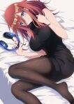  1girl bare_arms bare_shoulders bed_sheet black_pantyhose black_sweater blue_eyes blush breasts closed_mouth commentary_request dress go-toubun_no_hanayome hair_between_eyes headphones highres holding holding_headphones large_breasts long_hair long_hair_between_eyes looking_at_viewer lying nakano_miku nishizuki_shino on_back pantyhose red_hair ribbed_sweater sleeveless sleeveless_sweater sleeveless_turtleneck solo sweater sweater_dress thighs turtleneck turtleneck_sweater unworn_headphones 