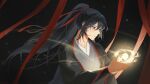  1boy 8083_blue aura bishounen black_background black_eyes black_hair black_hanfu chinese_clothes closed_mouth commentary_request floating floating_hair floating_object grey_eyes hair_between_eyes hair_ribbon hanfu holding light_particles long_hair long_sleeves looking_at_object male_focus modao_zushi orb ponytail red_ribbon ribbon robe sidelocks solo upper_body wei_wuxian wide_sleeves 