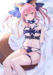  1girl animal_ear_fluff animal_ears bell blue_ribbon blush breasts collarbone commentary fate/extra fate/grand_order fate_(series) fox_ears fox_girl fox_tail hair_ribbon ice_(ice_aptx) large_breasts looking_at_viewer lying midriff navel on_back pink_hair ribbon solo tail tamamo_(fate)_(all) tamamo_no_mae_(fate) underboob underwear yellow_eyes 