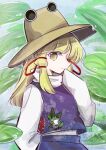  1girl animal_print blonde_hair brown_hat closed_mouth commentary frog frog_print hair_ribbon hat highres leaf long_hair long_sleeves looking_at_viewer moriya_suwako purple_skirt purple_vest red_ribbon ribbon skirt sleeves_past_fingers sleeves_past_wrists solo tama_(hiroshige_36) touhou tress_ribbon vest watermark wide_sleeves yellow_eyes 