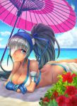  1girl absurdres ass bangs bare_shoulders beach beach_umbrella blue_eyes blue_sky breasts cleavage cloud cloudy_sky collarbone commentary_request dark_skin day dys eyebrows_visible_through_hair flower grey_hair hibiscus highres lips long_hair looking_at_viewer lying majikina_mina medium_breasts ocean on_stomach outdoors ponytail samurai_spirits shiny shiny_hair shiny_skin simple_background sky smile snk solo thighs tied_hair umbrella water 