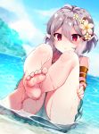  1girl ass bangs bare_legs bare_shoulders barefoot beniko_(ymdbnk) blurry blurry_background blush commentary_request day depth_of_field dutch_angle eyebrows_visible_through_hair feet flower green_swimsuit grey_hair hair_between_eyes hair_flower hair_ornament highres horizon knees_up kokkoro_(princess_connect!) legs looking_at_viewer ocean one-piece_swimsuit outdoors parted_lips pink_flower pointy_ears princess_connect! princess_connect!_re:dive red_eyes sitting soles solo swimsuit water wet white_flower 