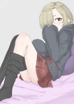  1girl absurdres black_hoodie black_legwear blonde_hair blush covering_mouth ear_piercing grey_background hair_over_one_eye highres hood hood_down hoodie idolmaster idolmaster_cinderella_girls knees_together_feet_apart kuzuuo leaning_back looking_at_viewer multiple_piercings on_bed oversized_clothes piercing pillow plaid plaid_skirt pleated_skirt red_eyes red_skirt shirasaka_koume short_eyebrows short_hair sitting skirt sleeves_past_fingers sleeves_past_wrists solo thighhighs thighhighs_pull 