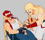  2boys andy_bogard armband artist_name blonde_hair braided_ponytail covered_eyes denim fatal_fury fatal_fury_cap fingerless_gloves gloves jacket jeans long_hair multiple_boys pants regiusfurca sleeveless terry_bogard theft 