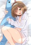  1girl :d ahoge ass bangs bed_sheet blush breasts brown_hair cleavage collared_shirt commentary_request dress_shirt eyebrows_visible_through_hair fang green_eyes hair_intakes hair_over_one_eye hairband haru_(kuzuyu) highres knee_up komori_kuzuyu long_sleeves looking_at_viewer lying naked_shirt navel object_hug on_side open_clothes open_mouth open_shirt original shirt sleeves_past_wrists small_breasts smile solo stuffed_animal stuffed_shark stuffed_toy white_hairband white_shirt 