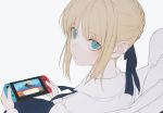  1girl ahoge artoria_pendragon_(all) bangs blonde_hair braid doubutsu_no_mori dress eyebrows_visible_through_hair fate/stay_night fate_(series) from_behind green_eyes hair_ribbon holding_handheld_game_console looking_at_viewer nintendo_switch playing ribbon saber simple_background sitting solo wanke white_background 