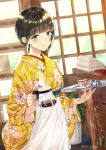  1girl apron bangs black_hair blue_eyes blurry blurry_background blush chair character_request coffee coffee_pot coffee_wo_shizuka_ni commentary_request cup depth_of_field eyebrows_visible_through_hair floral_print holding holding_tray indoors japanese_clothes kimono long_sleeves looking_at_viewer miyabi_akino obi parted_lips print_kimono sash saucer sidelocks smile solo tray twitter_username waist_apron waitress white_apron wide_sleeves yellow_kimono 