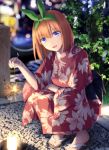  1girl :d bangs blue_eyes blurry blurry_background brown_footwear candle commentary_request depth_of_field eyebrows_visible_through_hair fireworks floral_print go-toubun_no_hanayome green_ribbon hair_between_eyes hair_ribbon haribote_(tarao) holding japanese_clothes kimono long_sleeves looking_at_viewer nakano_yotsuba night open_mouth orange_hair outdoors plant print_kimono red_kimono ribbon senkou_hanabi smile solo sparkler squatting wide_sleeves yukata zouri 