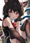  1girl :o animal_ears asymmetrical_wings bangs bare_shoulders black_dress black_hair black_legwear blue_wings blush bow bowtie cat_ears commentary_request dress eyebrows_visible_through_hair fang feet_out_of_frame hair_between_eyes highres houjuu_nue kemonomimi_mode knees_up looking_at_viewer petals red_bow red_eyes red_neckwear red_wings satoupote short_hair sitting sleeveless sleeveless_dress solo thighhighs thighs touhou wings 