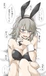  1girl alternate_costume animal_ears bangs bed_sheet black_leotard black_neckwear blue_eyes blush bow bowtie breasts bunny_ears bunnysuit collar commentary detached_collar elf_(stroll_in_the_woods) fake_animal_ears from_above girls_und_panzer head_tilt heart highres itsumi_erika legs_up leotard looking_at_viewer lying medium_breasts medium_hair on_back on_bed open_mouth silver_hair solo strapless strapless_leotard sweatdrop translated white_collar wing_collar wrist_cuffs 