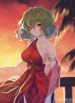  1girl alternate_costume armlet bangs bare_arms bare_shoulders breasts closed_mouth collarbone commission commissioner_upload cowboy_shot dress green_hair hair_between_eyes hand_on_railing highres kazami_yuuka large_breasts light_particles looking_at_viewer matsuda_toki medium_hair outdoors palm_tree railing red_dress red_eyes sash shawl signature single_strap smile solo standing strapless sunset touhou tree upper_body wavy_hair 