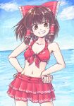  1girl alternate_costume aokukou bikini bow brown_eyes brown_hair cloud commentary frilled_bow frilled_hair_tubes frills grin hair_bow hair_tubes hakurei_reimu hands_on_own_hips light_blush looking_at_viewer medium_hair midriff navel open_mouth red_bikini red_bow smile solo swimsuit touhou water 