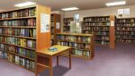  book bookshelf carpet ceiling ceiling_light highres indoors library non-web_source official_art our_life:_beginnings_and_always poster_(object) refrigerator scenery shadow table tile_ceiling tiles too_many too_many_books variant_set wooden_table 