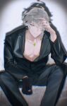  1boy absurdres ahoge alhaitham_(genshin_impact) black_gloves black_jacket black_pants chest_jewel feet_out_of_frame gem genshin_impact gloves green_eyes green_gemstone grey_hair hair_over_one_eye hand_up highres jacket jewelry lapels long_sleeves looking_at_viewer male_focus necklace one_eye_covered open_clothes open_jacket pants parted_bangs parted_lips pectorals ring sachico66 shadow short_hair single_glove sitting solo swept_bangs vignetting 