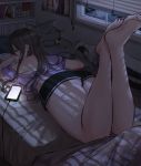  1girl bare_shoulders bed bedroom black_shorts blanket blinds blush book bookshelf brown_hair cellphone charging_device crop_top dark expulse highres indoors legs_up long_hair looking_back off_shoulder original phone purple_shirt reading shirt short_shorts shorts sidelocks smartphone studying stuffed_animal stuffed_toy thighs window 