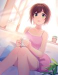  1girl backlighting bangs bare_arms bare_legs bare_shoulders brown_hair camisole coffee_mug collarbone commentary_request cup curtains dutch_angle eyebrows_visible_through_hair feet_out_of_frame flower_pot green_eyes highres holding holding_cup idolmaster idolmaster_cinderella_girls indoors kurageso leaf maekawa_miku mug open_window parted_lips pillow plant potted_plant short_hair sitting sleeves_past_wrists smile solo steam window 