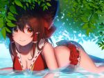  1girl adapted_costume bikini bikini_skirt bow breasts brown_hair cleavage emoriza hair_bow hair_tubes hakurei_reimu leaf lying medium_breasts medium_hair on_stomach orange_eyes partially_submerged smile solo swimsuit touhou tree_shade water 