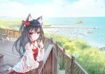  1girl animal_ears bare_shoulders bell black_hair cat_ears cat_girl cat_tail criss-cross_halter dress hair_bell hair_ornament hair_ribbon halterneck highres long_hair looking_at_viewer ocean original outdoors plant potted_plant red_eyes ribbon solo sxbzero tail 