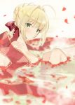  1girl ahoge bangs bathing blonde_hair blurry blush breasts closed_mouth collarbone commentary_request depth_of_field eyebrows_visible_through_hair fate/extra fate_(series) from_side green_eyes hair_intakes hair_ribbon highres knees_up looking_at_viewer looking_to_the_side matsuoka_(mtok_0) medium_breasts nero_claudius_(fate) nero_claudius_(fate)_(all) partially_submerged petals red_ribbon ribbon short_hair sidelocks sitting solo steam water 