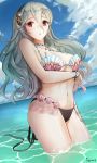  1girl artist_name bikini black_hairband blue_sky breasts cleavage cloud corrin_(fire_emblem) corrin_(fire_emblem)_(female) day fire_emblem fire_emblem_cipher fire_emblem_fates hairband highres ippers long_hair outdoors pointy_ears red_eyes shell shell_bikini sky solo swimsuit wading water white_hair 