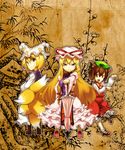  animal_ears blonde_hair bow brown_eyes brown_hair cat_ears chen closed_umbrella fox_tail hat hat_ribbon highres long_hair looking_back multiple_girls multiple_tails paw_pose planted_umbrella purple_eyes ribbon short_hair smile tail touhou umbrella very_long_hair yakumo_ran yakumo_yukari yuuzii 