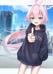  1girl absurdres ahoge aiming aiming_at_viewer alternate_costume black_hoodie blue_archive blurry blurry_background blush building commentary_request finger_gun floating_hair foreshortening hair_flaps halo hand_in_pocket heterochromia highres hood hoodie hoshino_(blue_archive) letterboxed long_hair long_sleeves looking_at_viewer miyuki_kotori no_pants ponytail rooftop smile solo thighs very_long_hair 