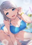  1girl :d absurdres all_fours bangs bare_arms bare_legs bare_shoulders barefoot bikini blue_bikini blue_eyes blurry blurry_background blush breasts cleavage collarbone commentary_request day depth_of_field dutch_angle eyebrows_visible_through_hair hair_tucking highres large_breasts looking_at_viewer love_live! love_live!_sunshine!! open_mouth outdoors poolside short_hair silver_hair smile solo sparkle swept_bangs swimsuit watanabe_you wristband yamaori_(yamaorimon) zipper 