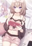  1girl :t bare_shoulders black_shirt blurry bow breasts brown_hair brown_shorts camisole cleavage collarbone crop_top depth_of_field game_console hair_bow hair_flaps highres holding index_finger_raised long_hair looking_at_viewer medium_breasts midriff navel nintendo_switch off_shoulder open_clothes open_shirt original pout purple_eyes sapphire_(sapphire25252) shirt short_shorts shorts sitting solo spaghetti_strap strap_slip v-shaped_eyebrows wide_sleeves 