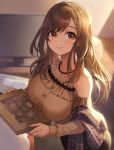  1girl blush breasts brown_hair brown_shirt chocolate closed_mouth commentary_request eyebrows_visible_through_hair highres idolmaster idolmaster_shiny_colors indoors large_breasts long_hair nhaliz red_eyes shirt solo television tsukioka_kogane 