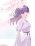  1girl arms_behind_back bangs blush breasts cherry_blossoms dress eyebrows_visible_through_hair fate/stay_night fate_(series) hair_ribbon long_hair looking_at_viewer matou_sakura open_mouth petals purple_eyes purple_hair red_ribbon ribbon short_sleeves siino smile solo 