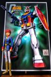  1boy amuro_ray beam_rifle brown_hair clenched_hands cody_(jkglfkfkxfi9ttg) copyright_name energy_gun figure gun gundam gunpla highres holding holding_gun holding_shield holding_weapon logo looking_to_the_side mecha mobile_suit_gundam model_kit photo rx-78-2 shield v-fin weapon 