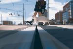  1girl animal bag blurry blurry_background building cat city cloud commentary day depth_of_field english_commentary highres legs loafers lower_body original outdoors pleated_skirt road school_uniform shoes skirt sky snatti socks solo stuffed_animal stuffed_toy walking 