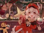  1girl artist_name blonde_hair box brown_gloves christmas christmas_ornaments christmas_tree dress genshin_impact gift gift_box gloves holding holding_gift klee_(genshin_impact) long_sleeves open_mouth orange_eyes pointy_ears red_dress red_headwear seigaaaa smile solo twintails 