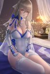  1girl absurdres asymmetrical_legwear azur_lane bedside blue_bow bow breasts city_lights cityscape cleavage dress elbow_gloves fingerless_gloves gloves grey_hair highres lamp large_breasts long_hair mole mole_under_eye red_eyes saint-louis_(azur_lane) saint-louis_(brilliant_paladin)_(azur_lane) single_thighhigh skyline thighhigh_removed thighhighs white_dress white_legwear window you_(yoyou) 