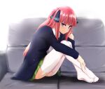  1girl aoyama_kiiro ass bangs black_cardigan black_ribbon blue_eyes blunt_bangs blush butterfly_hair_ornament cardigan couch feet go-toubun_no_hanayome hair_ornament hime_cut hugging_own_legs knees_to_chest knees_up long_hair looking_at_viewer nakano_nino open_cardigan open_clothes pink_hair ribbon shirt sitting smile soles thick_thighs thighhighs thighs twintails white_legwear white_shirt 