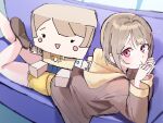  1girl 4ding :d :t box brown_hair brown_jacket cardboard_box character_and_character_item character_doll closed_mouth commentary couch doll highres hood hood_down hooded_jacket jacket kasumin_box long_sleeves looking_at_viewer love_live! love_live!_nijigasaki_high_school_idol_club lying nakasu_kasumi on_couch on_stomach open_mouth pink_eyes pout raised_inner_eyebrows short_hair shorts smile solo yellow_hood yellow_shorts 