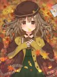  1girl aizawa85 autumn autumn_leaves bangs beret book brown_eyes brown_hair brown_headwear brown_jacket closed_mouth dress eyebrows_visible_through_hair fringe_trim ginkgo_leaf green_dress hair_between_eyes hat holding holding_book jacket leaf long_hair long_sleeves looking_at_viewer lying maple_leaf mouth_hold on_back open_book open_clothes open_jacket original shawl sleeves_past_wrists smile solo 