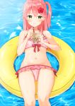  1girl alternate_costume bare_shoulders bikini blush bubble_tea cherry_blossom_print drinking_straw floral_print flower green_eyes groin hair_flower hair_ornament hibiscus highres hololive innertube mirai_(mirai76_) navel pink_bikini pink_hair sakura_miko solo swimsuit virtual_youtuber water 