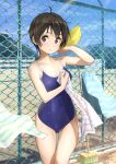  1girl ahoge blue_sky blue_swimsuit brown_eyes brown_hair chain-link_fence cleaning_brush cloud competition_school_swimsuit cowboy_shot day domo1220 fence looking_at_viewer original outdoors school_swimsuit short_hair sky solo standing striped_towel swimsuit 