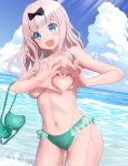  1girl :d bangs bikini bikini_removed black_bow blue_eyes blue_sky blunt_bangs blush bow breasts cloud cloudy_sky collarbone contrapposto cowboy_shot day frills fujiwara_chika gibun_(sozoshu) green_bikini hair_bow heart heart-shaped_boob_challenge heart_hands highres kaguya-sama_wa_kokurasetai_~tensai-tachi_no_renai_zunousen~ long_hair looking_at_viewer medium_breasts navel ocean open_mouth outdoors pink_hair sky smile solo stomach swimsuit topless wading water 