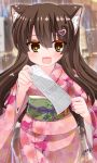  1girl :d animal_ear_fluff animal_ears blurry blurry_background brown_eyes brown_hair commentary_request depth_of_field floral_print hair_between_eyes hair_ornament heart heart_hair_ornament highres holding japanese_clothes kanijiru kimono long_hair long_sleeves looking_at_viewer obi omikuji original pink_kimono print_kimono sash signature smile solo very_long_hair wide_sleeves 
