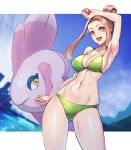  1girl :d alomomola arm_up armpits ass_visible_through_thighs bangs bare_shoulders bikini blue_sky breasts brown_eyes brown_hair cleavage clenched_hand cloud collarbone commentary_request cowboy_shot gen_5_pokemon green_bikini groin hair_bun highres holding holding_poke_ball looking_at_viewer midriff navel npc_trainer ocean open_mouth parted_bangs poke_ball poke_ball_(basic) pokemon pokemon_(creature) pokemon_(game) pokemon_bw sky smile standing swimmer_(pokemon) swimsuit upper_teeth yasu_suupatenin 