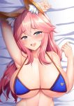  1girl animal_ear_fluff animal_ears bed_sheet bikini bikini_top blue_bikini blue_eyes breasts eyebrows_visible_through_hair fate/grand_order fate_(series) fox_ears highres kisaragi_nana large_breasts long_hair looking_at_viewer lying on_back open_mouth pink_hair smile solo sweat swimsuit tamamo_(fate)_(all) tamamo_no_mae_(swimsuit_lancer)_(fate) teeth upper_body upper_teeth 